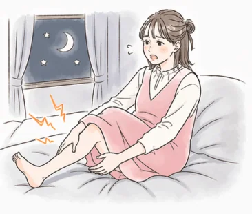 夜中にベッドで足がつって目を覚ます妊婦さん