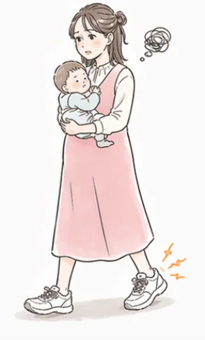 赤ちゃんを抱っこして歩くママ